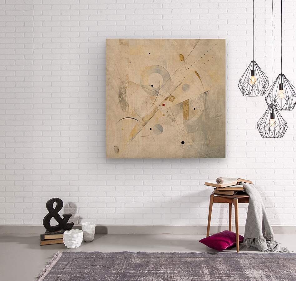 An abstract canvas art print with beige, gold, and gray brushstrokes hanging on a white brick wall in a styled room setting with a side table, pendant lights, and a rug.